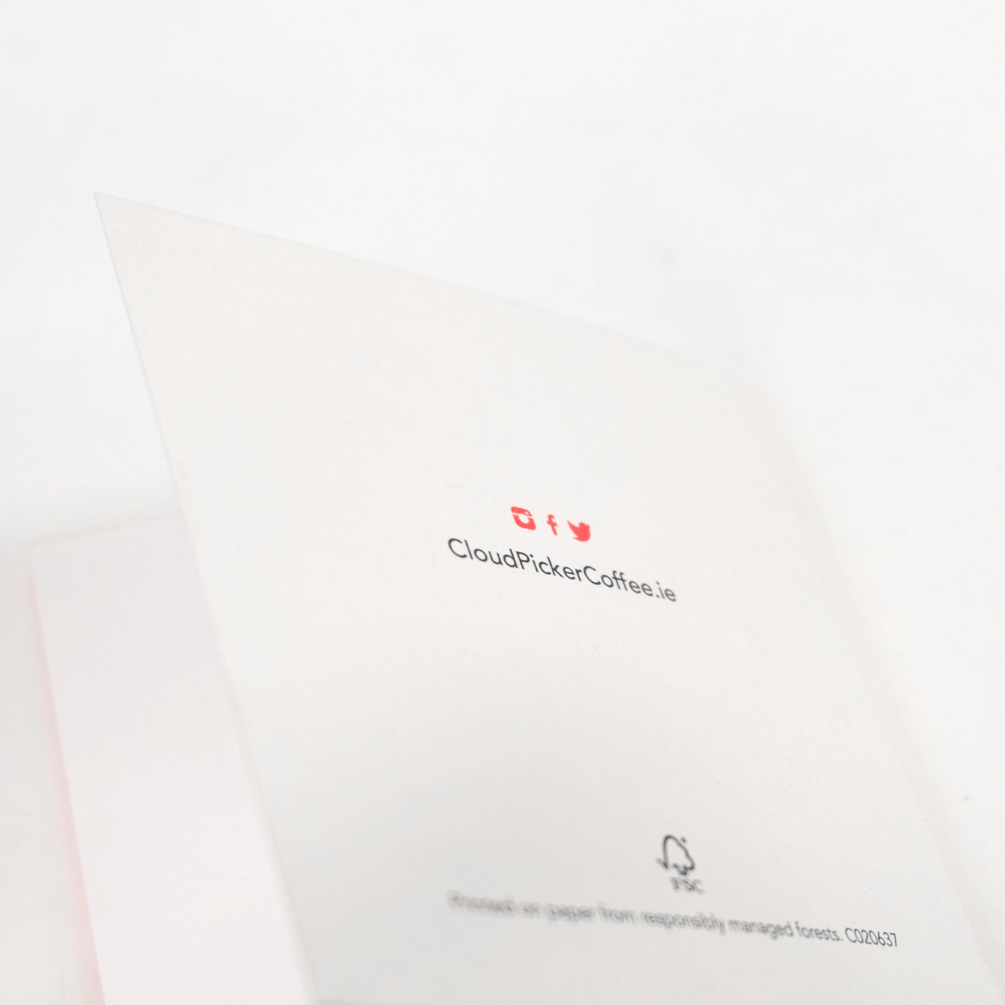Close-up of a handwritten card accessory by Cloud Picker Coffee, featuring elegant, personalized calligraphy on textured paper.