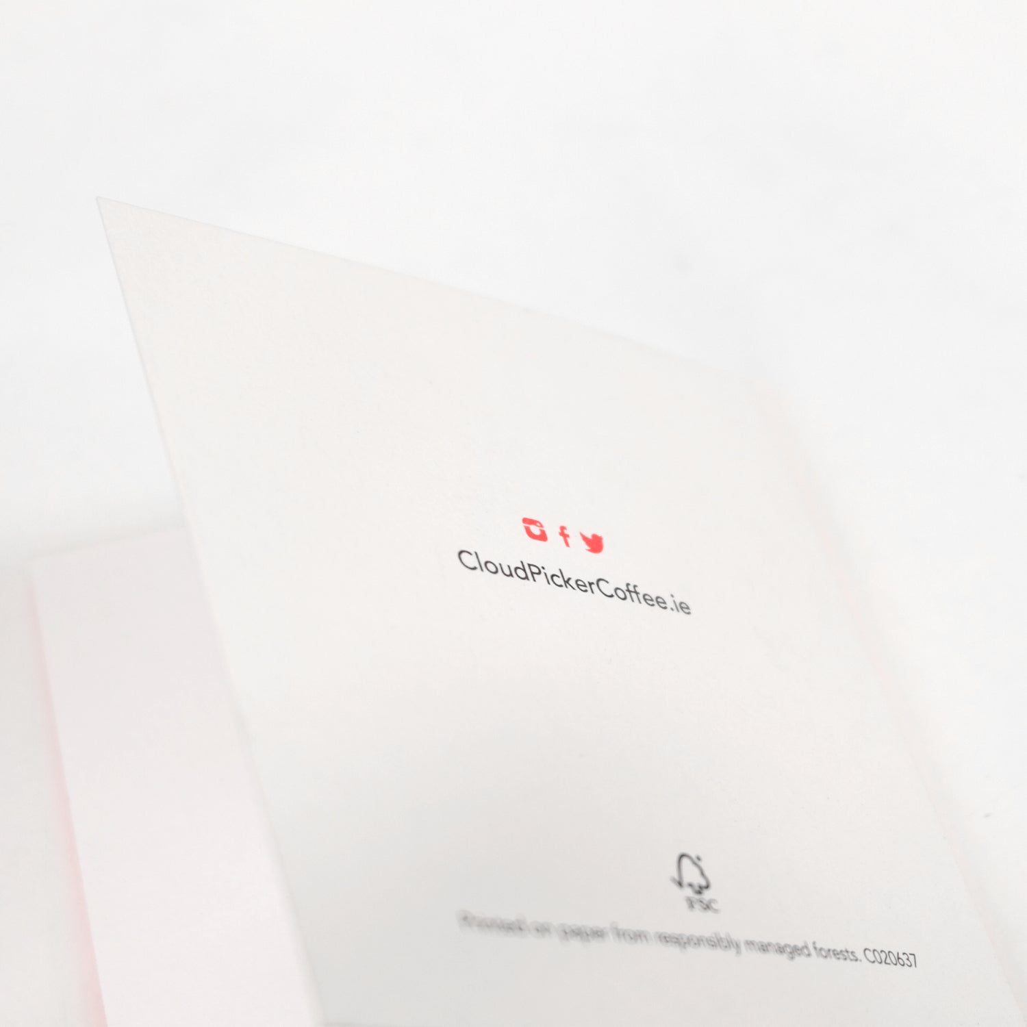 Close-up of a handwritten card accessory by Cloud Picker Coffee, featuring elegant, personalized calligraphy on textured paper.