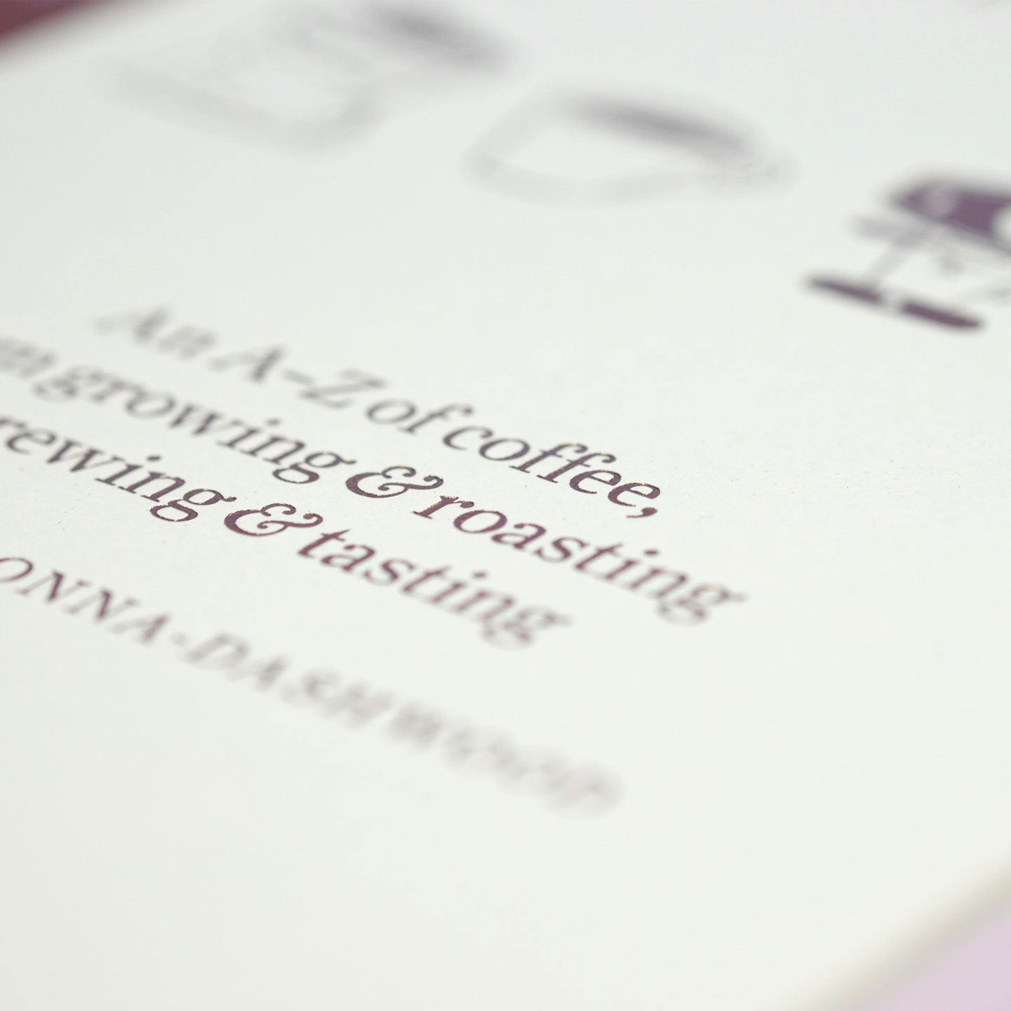 Close-up of The Coffee Dictionary accessory by Cloud Picker Coffee, featuring detailed pages and coffee-related illustrations.