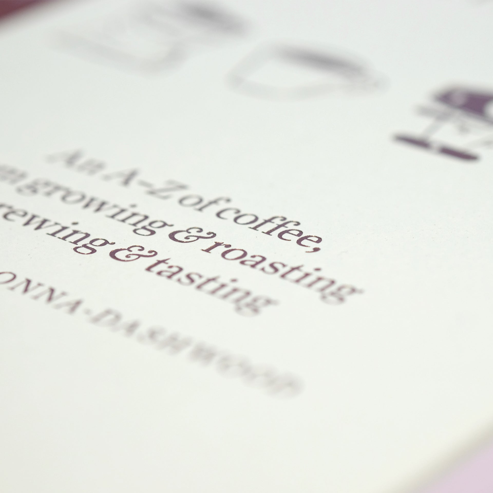 Close-up of The Coffee Dictionary accessory by Cloud Picker Coffee, featuring detailed pages and coffee-related illustrations.