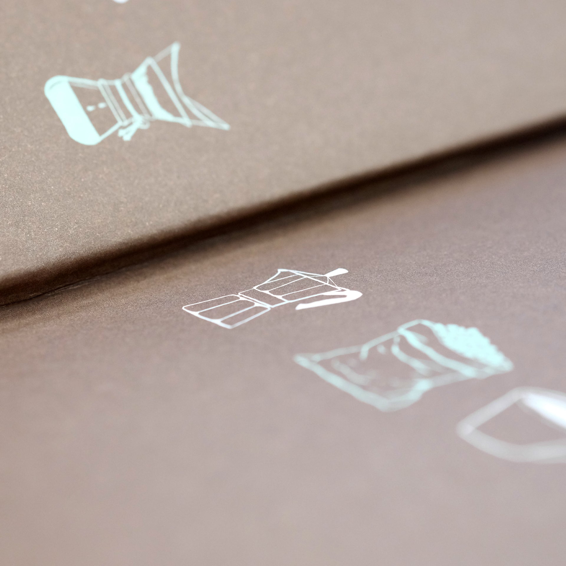 Close-up of The Coffee Dictionary accessory by Cloud Picker Coffee, showing detailed pages and coffee-related illustrations.