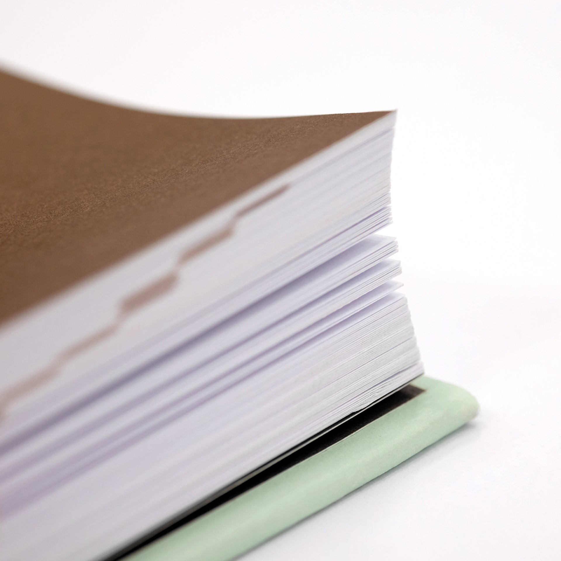 Close-up of The Coffee Dictionary accessory by Cloud Picker Coffee, showing detailed pages and coffee-related illustrations.