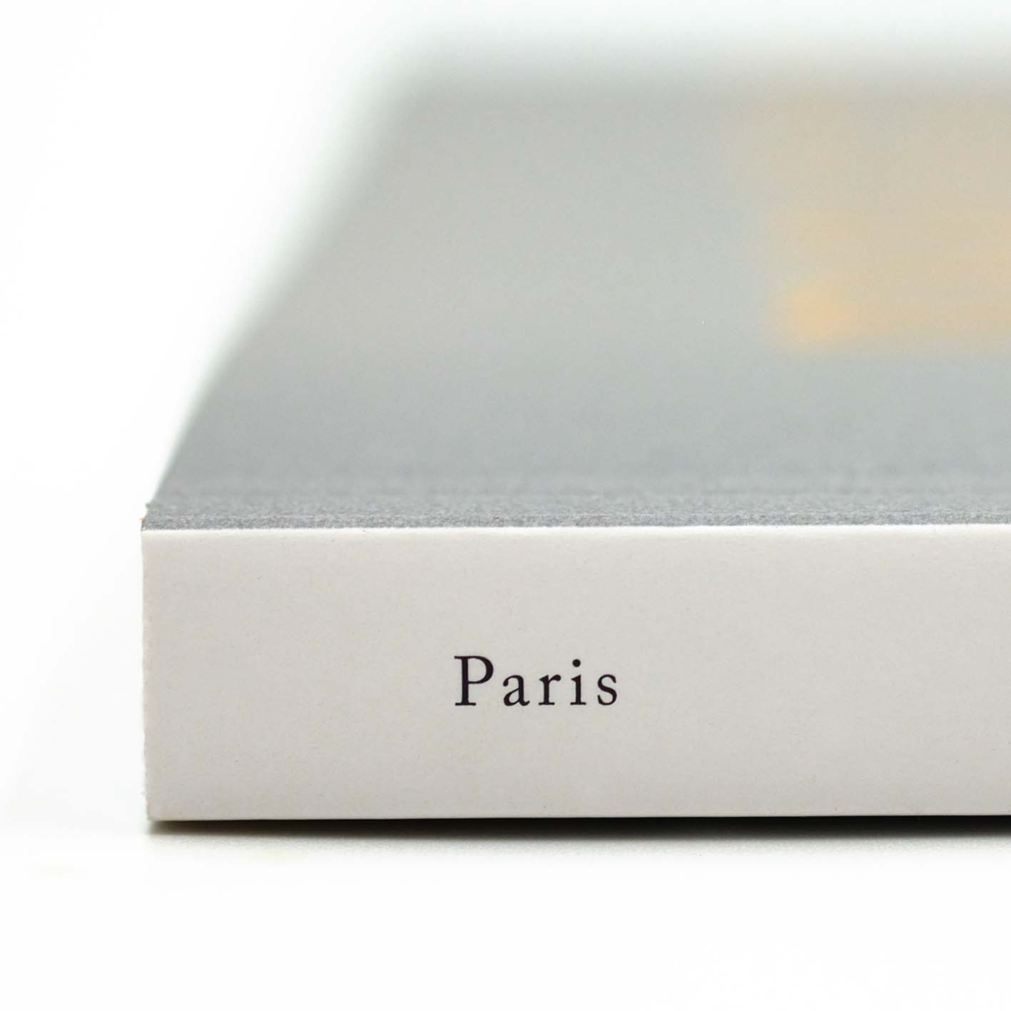 Close-up of Drift Magazine accessory by Cloud Picker Coffee, featuring a stylish design on a Paris-themed background.