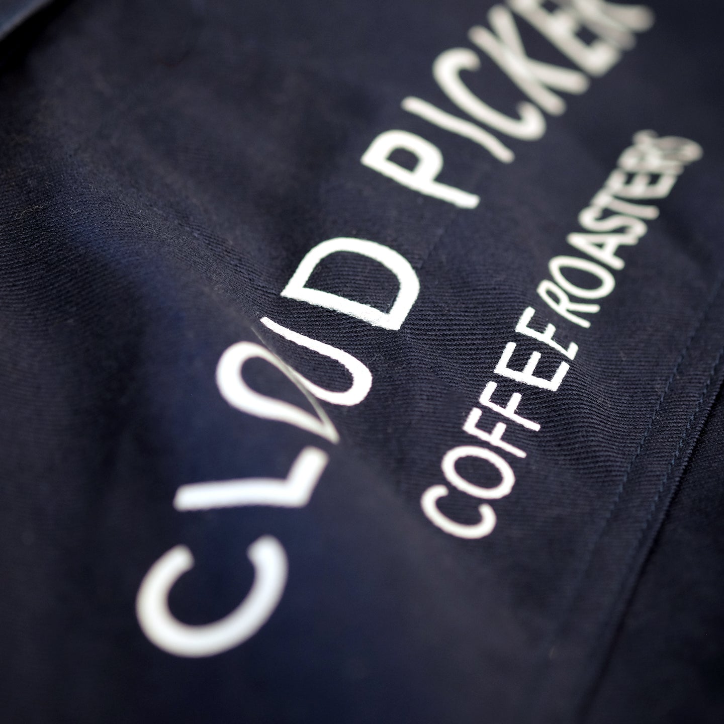Unisex Cloud Picker Coffee roaster jacket with durable fabric and branding, designed for professional coffee roasting.