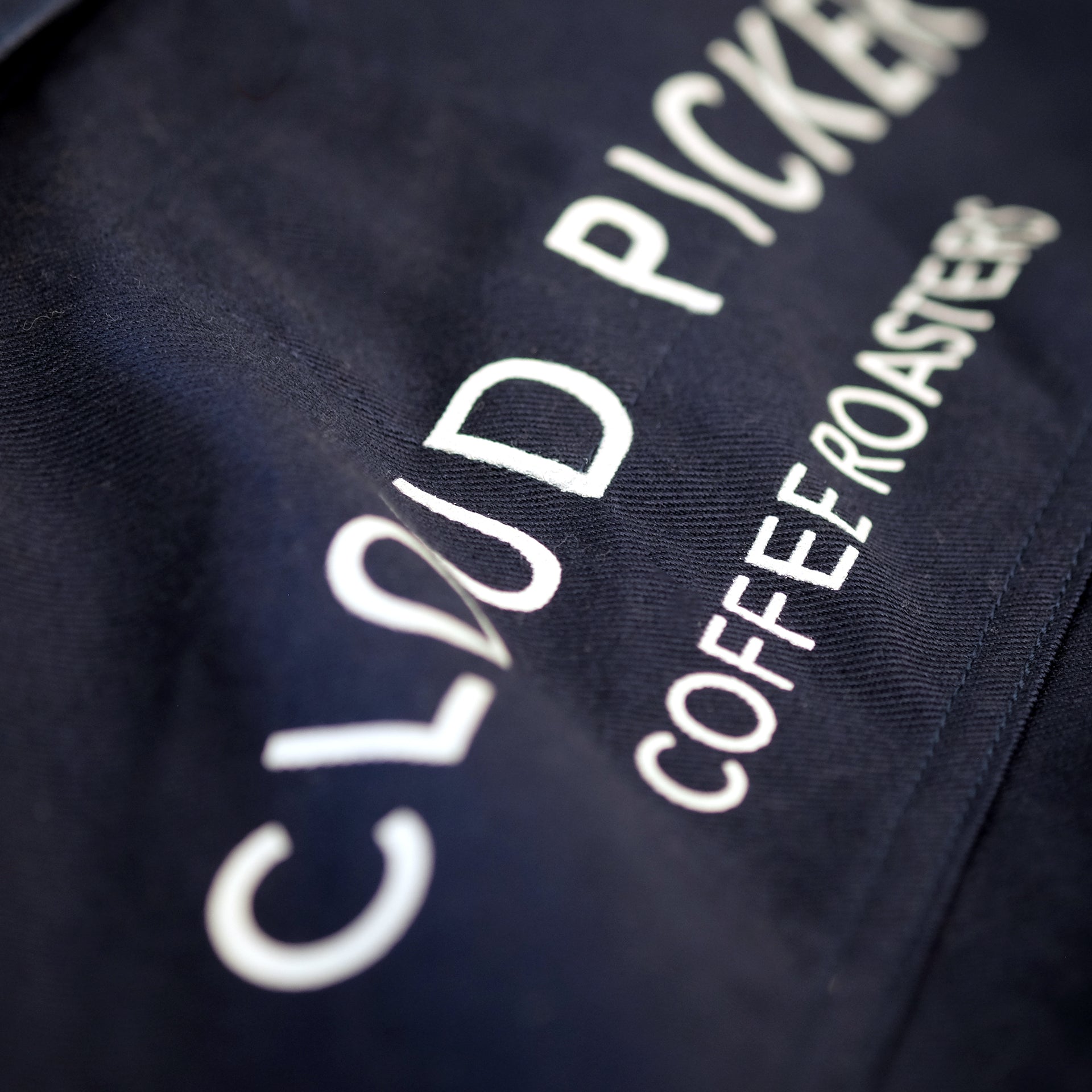 Unisex Cloud Picker Coffee roaster jacket with durable fabric and branding, designed for professional coffee roasting.