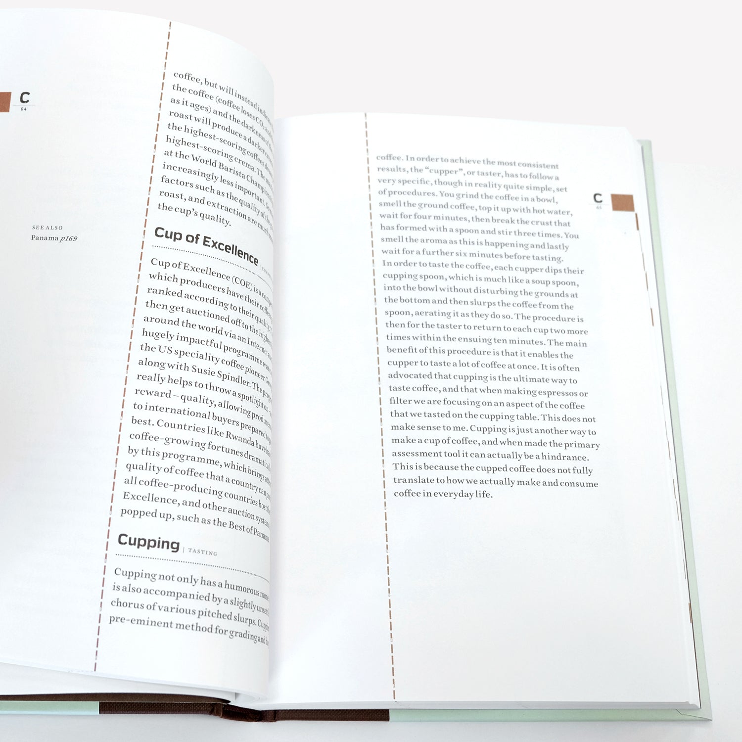 Open spread of "The Coffee Dictionary" accessory book by Cloud Picker Coffee, featuring pages with coffee terminology and illustrations.