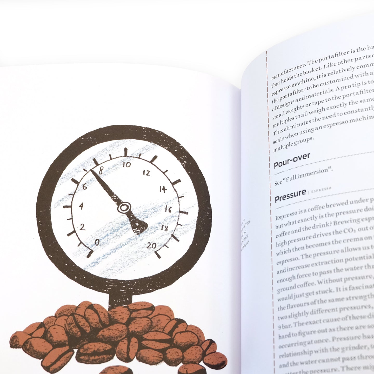 Open spread of The Coffee Dictionary accessories by Cloud Picker Coffee, showcasing pages with coffee-related terms and illustrations.