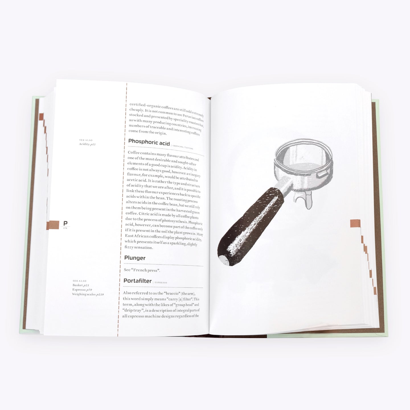 Open page of The Coffee Dictionary accessory by Cloud Picker Coffee showing coffee brewing terms and illustrations.